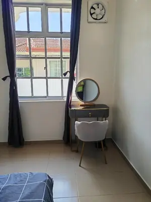 a bedroom with a desk and a mirror and a window at Padang Serai Cozy Roomstay Share Bathroom in Padang Serai