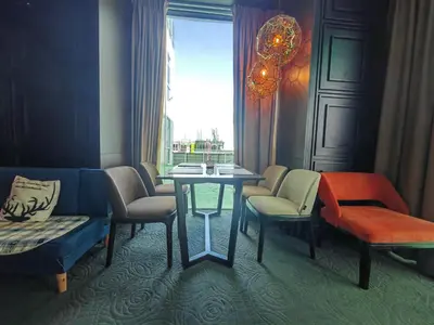 a room with chairs and a table and a window at Maritime Cozy Suite @ Penang Georgetown in Jelutong