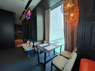 a room with a table and chairs and a window at Maritime Cozy Suite @ Penang Georgetown in Jelutong