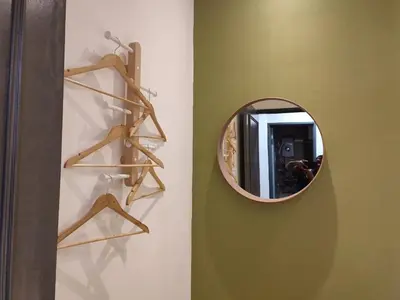 a mirror on a wall next to a bathroom at Adik aisyah muji pistachio homestay cameron highlands in Tanah Rata