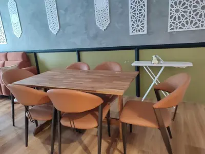 a table and chairs in a room with a table at Adik aisyah muji pistachio homestay cameron highlands in Tanah Rata