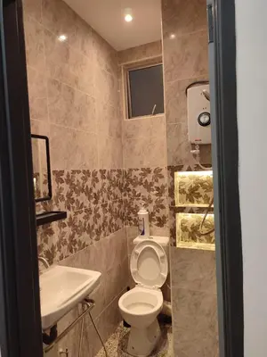 a bathroom with a toilet and a sink at Adik aisyah muji pistachio homestay cameron highlands in Tanah Rata