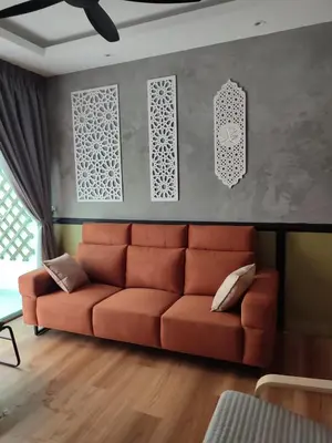 a living room with a orange couch in a room at Adik aisyah muji pistachio homestay cameron highlands in Tanah Rata