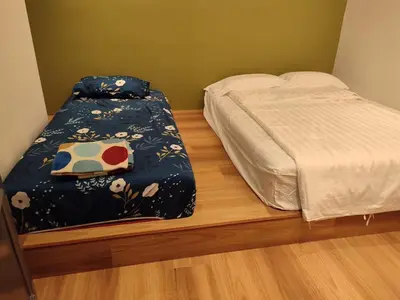 a bedroom with a bed with a blanket on it at Adik aisyah muji pistachio homestay cameron highlands in Tanah Rata