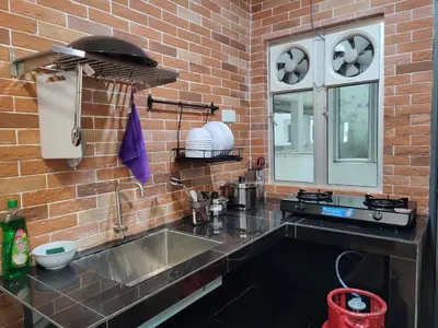 a kitchen with a sink and a brick wall at Adik aisyah muji pistachio homestay cameron highlands in Tanah Rata