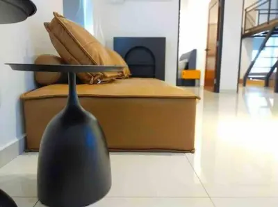 a black vase sitting on the floor next to a bed at Dawn de Ville-Private Pool BBQ Karaoke 34-40pax in Ipoh