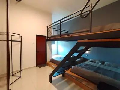 a bedroom with two bunk beds in a room at Dawn de Ville-Private Pool BBQ Karaoke 34-40pax in Ipoh