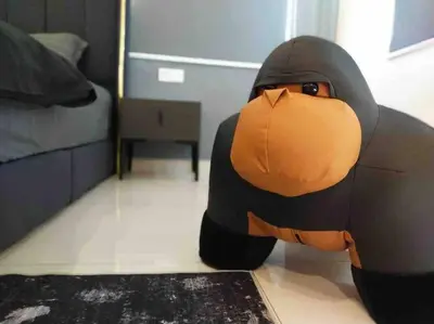 a large stuffed animal laying on the floor in a bedroom at Dawn de Ville-Private Pool BBQ Karaoke 34-40pax in Ipoh