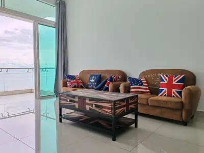 a living room with a couch and a coffee table at Invincible Seaview Vacation Condo 3R3B 8Pax in Bayan Lepas