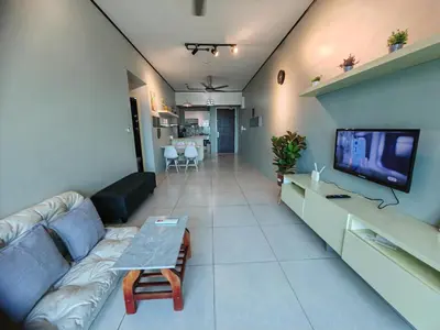 a living room with a couch and a tv at Modern Comfy Suite Room-9Pax in Perai