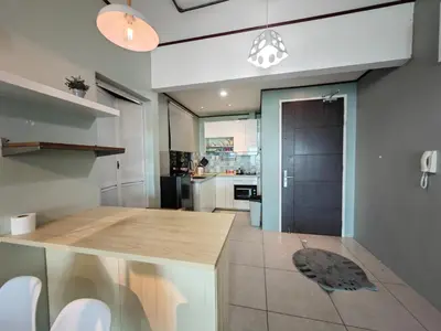 a kitchen with a wooden counter top in a room at Modern Comfy Suite Room-9Pax in Perai