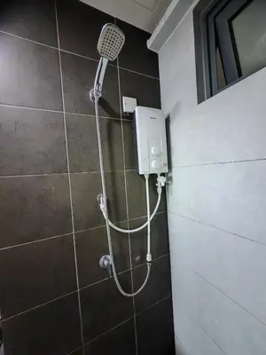 a shower in a bathroom with a shower head at Modern Comfy Suite Room-9Pax in Perai