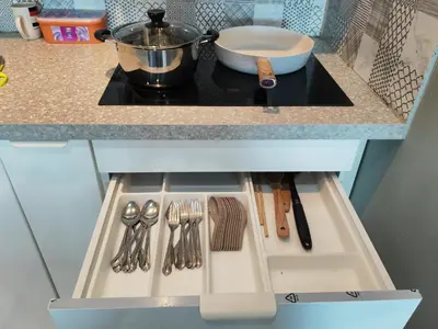 a kitchen counter with a stove with utensils on it at Modern Comfy Suite Room-9Pax in Perai