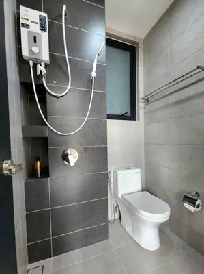 a small bathroom with a toilet and a shower at Urban Muji Retreat Suites #3BR #2carparks in Jelutong