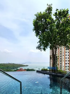 a swimming pool with a tree and a building at Urban Muji Retreat Suites #3BR #2carparks in Jelutong