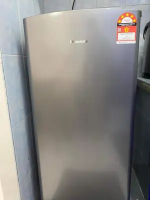 a metal refrigerator in a kitchen with a sign on it at HOMESTAY ANGGUN SAFIYYA in Bayan Lepas