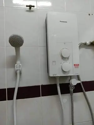 a shower in a bathroom with a water hose at HOMESTAY ANGGUN SAFIYYA in Bayan Lepas