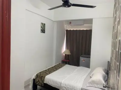 a bedroom with a bed with a ceiling fan at HOMESTAY ANGGUN SAFIYYA in Bayan Lepas