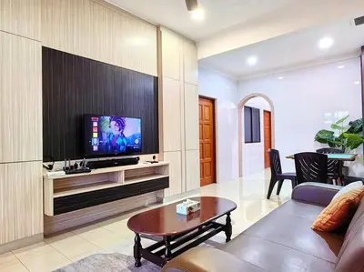 a living room with a flat screen tv on a wall at 【Ipoh Garden】4Br/8pax All Attractions w/in 15mins in Ipoh