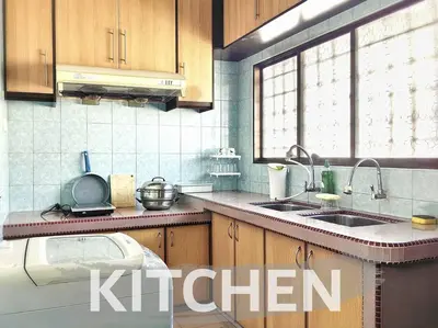 a kitchen with wooden cabinets and a kitchen sink at 【Ipoh Garden】4Br/8pax All Attractions w/in 15mins in Ipoh