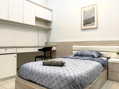 a bedroom with a bed and a chair in it at 【Ipoh Garden】4Br/8pax All Attractions w/in 15mins in Ipoh