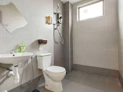 a bathroom with a toilet and a sink at 15-19Pax SemiD Near Highwy W/Pool Table&Karaoke in Ipoh