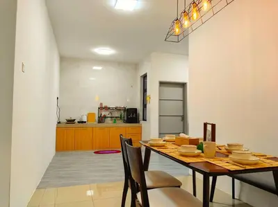 a dining room with a table and a kitchen at 15-19Pax SemiD Near Highwy W/Pool Table&Karaoke in Ipoh