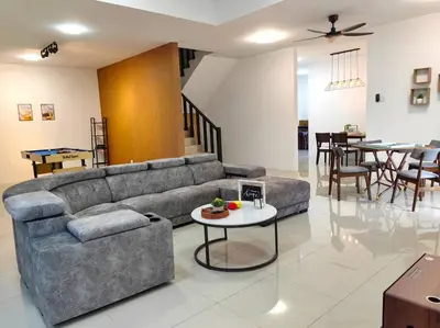 a living room with a couch and a table at 15-19Pax SemiD Near Highwy W/Pool Table&Karaoke in Ipoh