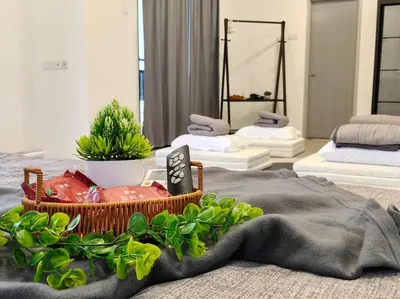 a room with two beds and a basket of plants at 15-19Pax SemiD Near Highwy W/Pool Table&Karaoke in Ipoh