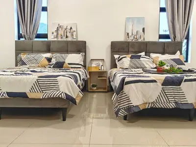 two beds sitting next to each other in a bedroom at 15-19Pax SemiD Near Highwy W/Pool Table&Karaoke in Ipoh