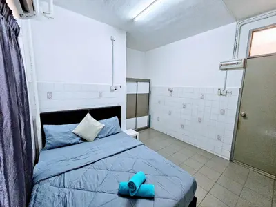 a bedroom with a bed with blue pillows on it at PANCHOR 6 HOSTEL in George Town
