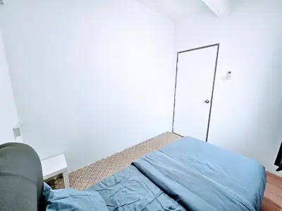 a bedroom with a blue bed and a mirror at PANCHOR 6 HOSTEL in George Town
