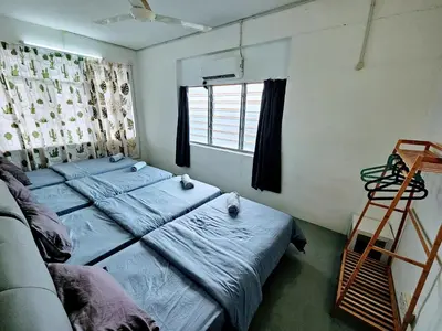 two beds in a room with a ladder and a window at PANCHOR 6 HOSTEL in George Town