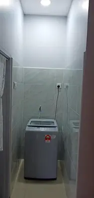 a small bathroom with a trash can in the corner at Pantai Remis Homestay 118A in Pantai Remis