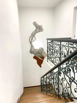 a staircase with a sculpture of a branch on the wall at Garden view bangalow wedding 12pax in Butterworth