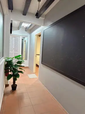 a hallway with a large blackboard on a wall at The Family Suit in George Town