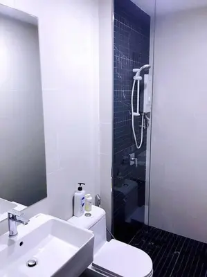a bathroom with a toilet and a sink and a shower at Beacon Suites #Georgetown #RoofTopPool #23 #2Bedrooms in George Town
