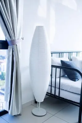 a white vase sitting next to a bed in a room at Beacon Suites #Georgetown #RoofTopPool #23 #2Bedrooms in George Town