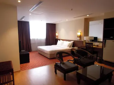 a hotel room with a bed and a desk at Hotel Excelsior Ipoh in Ipoh