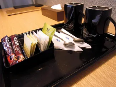 a black tray with scissors and other items on a table at Hotel Excelsior Ipoh in Ipoh