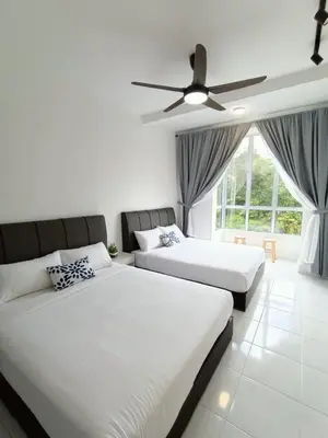 a bedroom with two beds and a ceiling fan at Dream 5 @ Emerald avenue in Brinchang