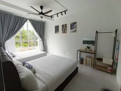 a bedroom with two beds and a ceiling fan at Dream 5 @ Emerald avenue in Brinchang