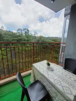 a table and chairs on a balcony with a view at Dream 5 @ Emerald avenue in Brinchang