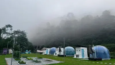 a group of blue domes in a field with trees at The Starry Dome Family Room 2A 2K in Cameron Highlands