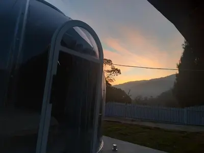 an open door of a car with a sunset in the background at The Starry Dome Family Room 2A 2K in Cameron Highlands