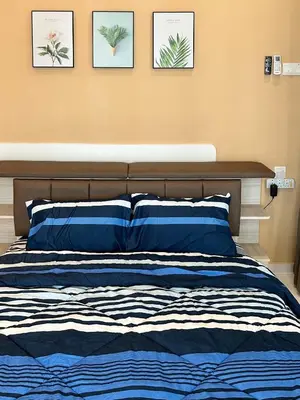 a bedroom with a bed with three pictures on the wall at Peak Homestay@Ipoh Perak Malaysia 10-14Pax 5R/6B in Lahat