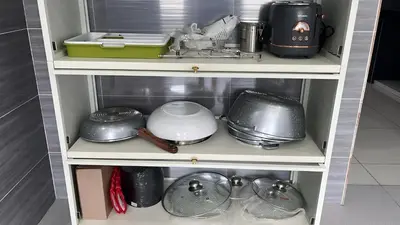 a shelf with pots and pans and other kitchen items at Peak Homestay@Ipoh Perak Malaysia 10-14Pax 5R/6B in Lahat
