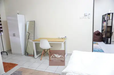 a room with a desk and a white chair at HAZZ Homestay Kulim in Kulim