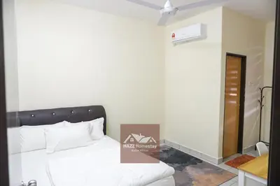 a room with a bed and a ceiling fan at HAZZ Homestay Kulim in Kulim