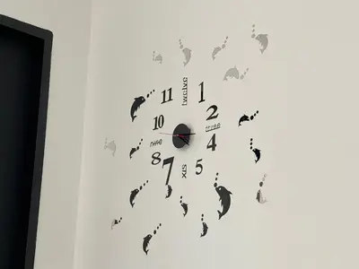 a clock with bats on a white wall at Urban Suites - Dolphin's Home in Jelutong